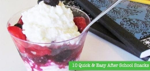 Dessert with berries and whipped cream in a glass with a spoon