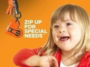 A child with Down syndrome smiles near a zipper pull featuring the "Zip Up for Special Needs" logo.
