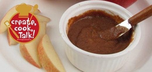 Caramel apple spread in a white bowl with apple slices.