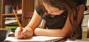 Child writing with a pencil.