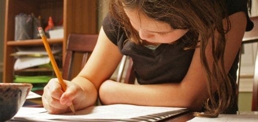Child writing with a pencil.