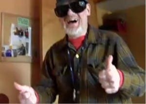 Camphill California resident wearing sunglasses and a plaid shirt gives two thumbs up to the camera.