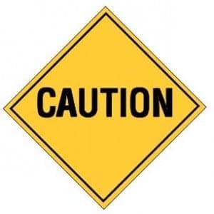 Yellow diamond-shaped sign with the word CAUTION in bold black text, signaling a need for awareness regarding subtle abuse.