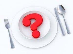 Large red question mark sitting on a dinner plate to represent uncertainty about the safety of food ingredients.