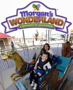 A woman and a boy in a wheelchair enjoy a ride at Morgan's Wonderland, a special place for special friends.