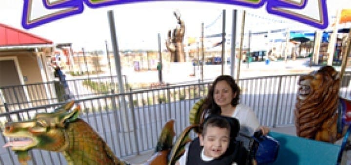 A woman and a boy in a wheelchair enjoy a ride at Morgan's Wonderland, a special place for special friends.