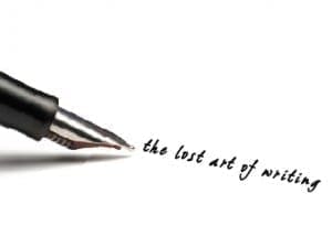 Fountain pen writing "the lost art of writing" on a white surface.