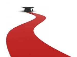 A red carpet leads to a graduation cap on a white background.