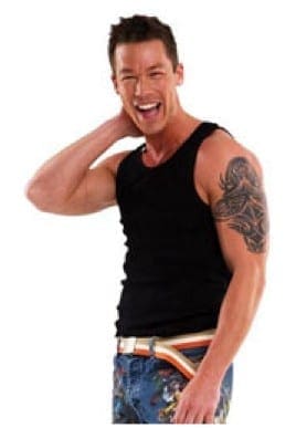 Man with dark hair and a black tank top laughs with his arm behind his head.