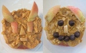 Apple halves topped with peanut butter and chocolate chips arranged into two distinct, fun faces.
