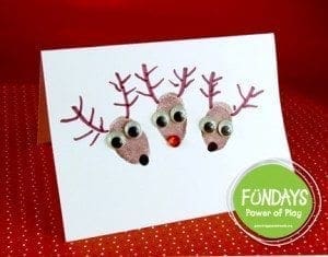 Three fingerprint reindeer with googly eyes and red noses on a card.