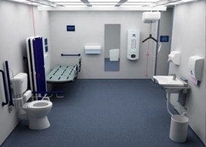 Accessible changing facility with a toilet, sink, changing bench, and grab bars.