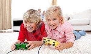 Two children excitedly play a video game with controllers.