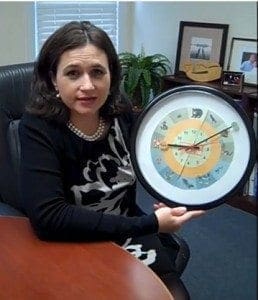 Sarah Ward holds a Wondertime Clock, designed to help children sense the sweep of time.