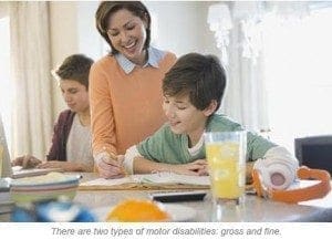A woman helps two boys with schoolwork at a table.