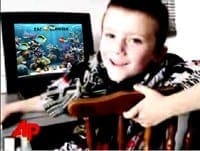 Smiling child using the underwater-themed Zac Browser interface on a computer to support focused learning.