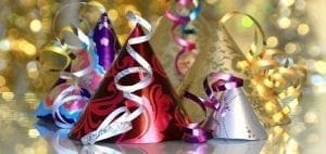 Party hats with ribbons and bokeh lights