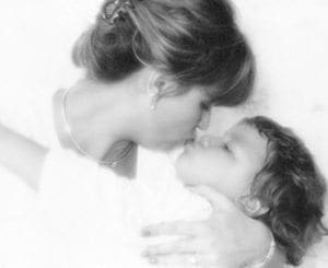 Mother and child share a tender moment, kissing