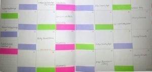Calendar with colored sticky notes marking events and available days.