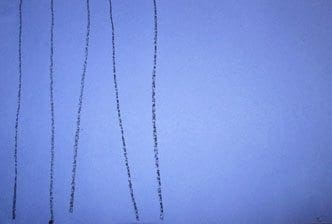 Black crayon lines drawn vertically on a light blue background.