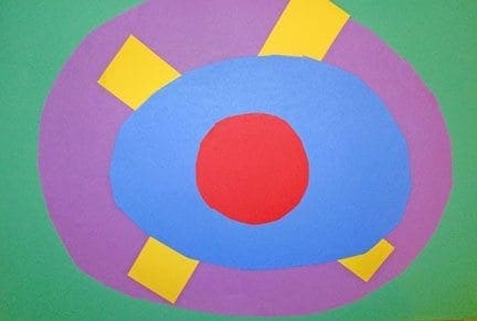 A colorful craft project inspired by Georgia O'Keeffe's flower paintings, with a red circle at the center of blue and purple