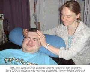 Reiki practitioner performing a session on a young person with a learning disability.