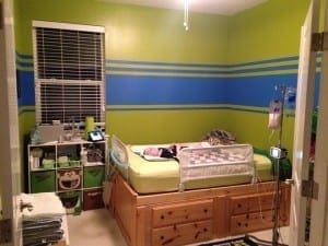 Room with a bed, cubby storage, and medical equipment.