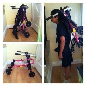 A custom carrier made from a backpack holds a reverse walker for a child.