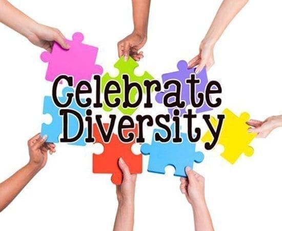 Hands holding colorful puzzle pieces forming the words "Celebrate Diversity.