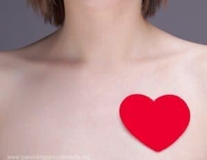 Red heart on a person's chest, symbolizing heart health.