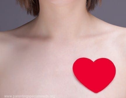 Red heart on a person's chest, symbolizing heart health.