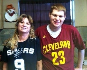 Ethan and his mother stand together, both wearing jerseys.