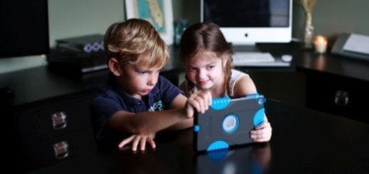 Two children look at a tablet computer together.