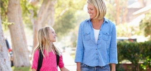 Woman and child walking and talking outdoors.