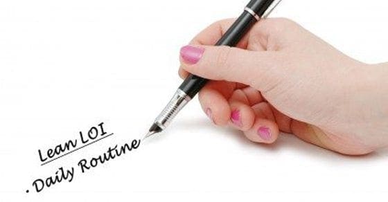Hand writing "Lean LOI - Daily Routine" on white surface