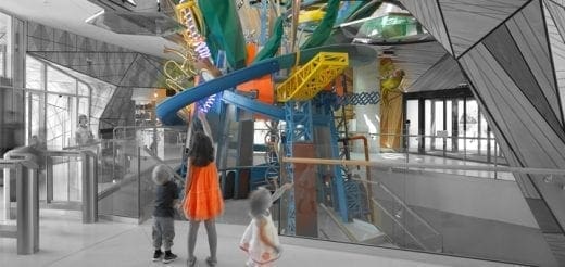 Children looking at a colorful, multi-level exhibit inside Edventure Children's Museum.