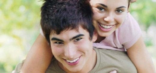 Teen couple smiling outdoors