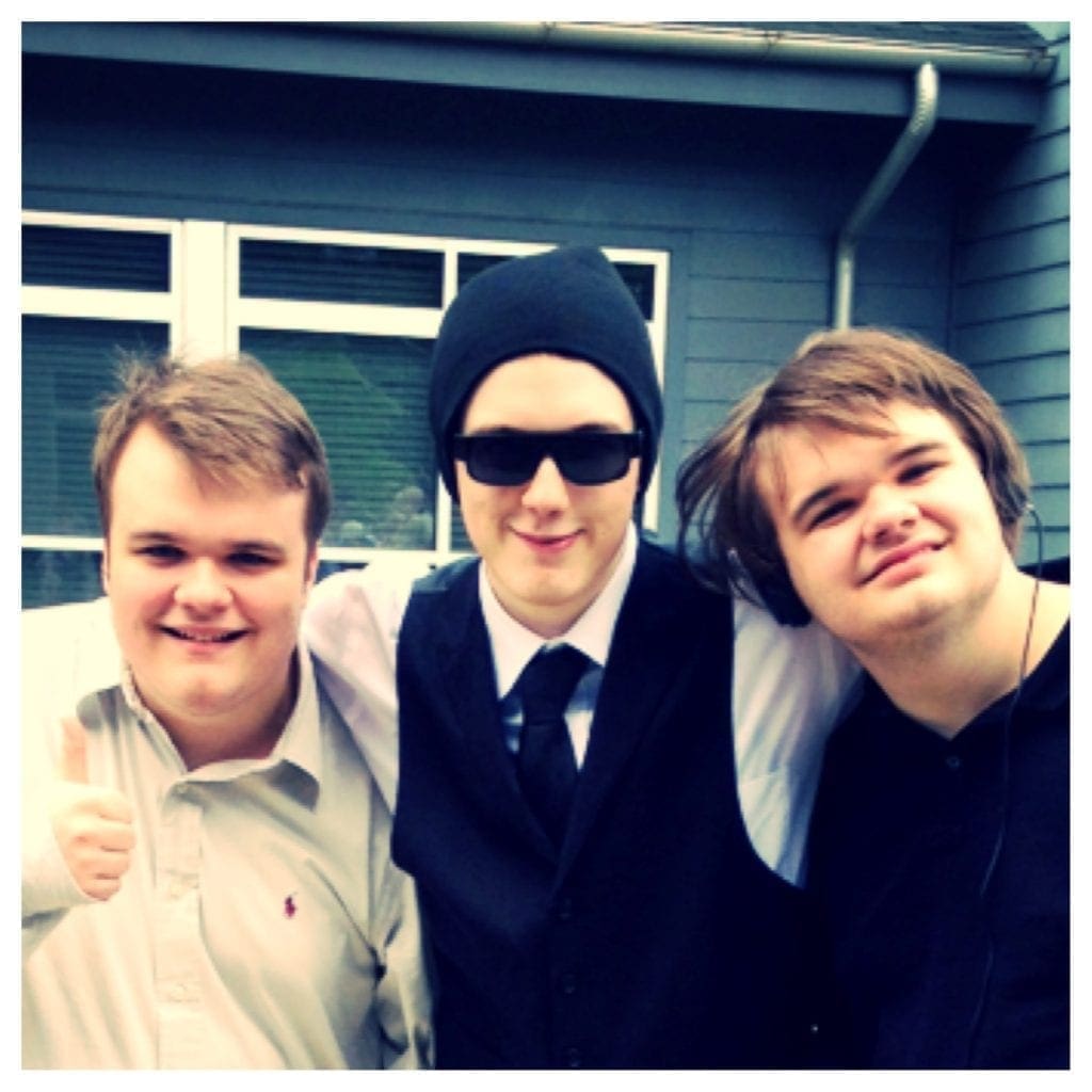 John, Joe Jr., and Robert smiling outside.