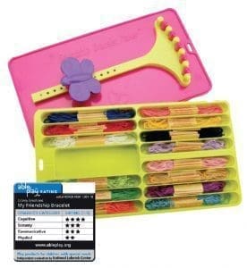 Friendship bracelet maker with colorful embroidery floss and a pink plastic loom.