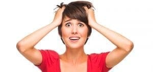 Woman with hands on head looking stressed
