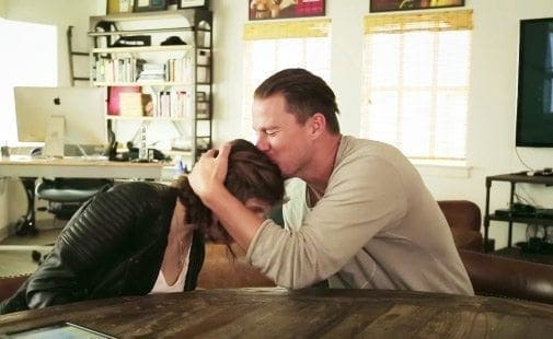 Channing Tatum kisses Carly's head while she leans forward.