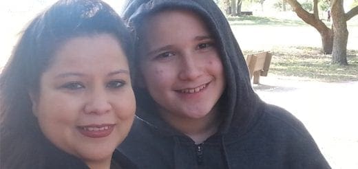 Richie and his mother smiling outdoors.