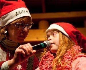 DeAnna Pursai and Cassie Wootan hold a microphone for a performance.