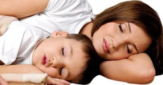 Mother and child sleeping peacefully together.
