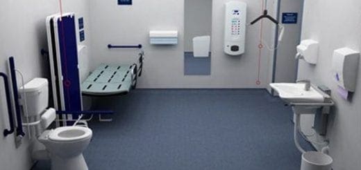 Accessible bathroom with toilet, changing table, and sink.