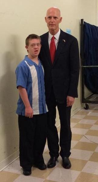 Matthew and a man in a suit and tie.