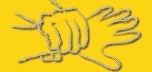 Two yellow hands making a puppet shape on a yellow background.