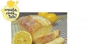 Lemon pound cake with lemons on a cooling rack