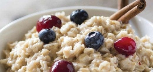 Oatmeal with blueberries, cranberries, and cinnamon sticks.