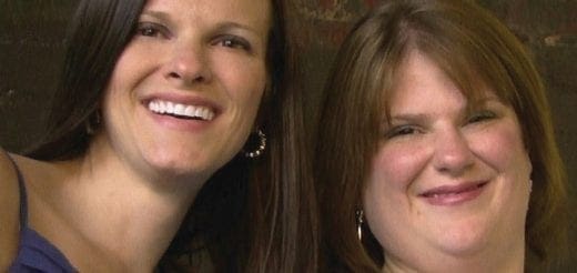 Two smiling women with dark and brown hair.
